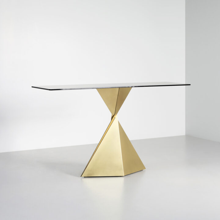 Made with Brass paired with a smoked glass top