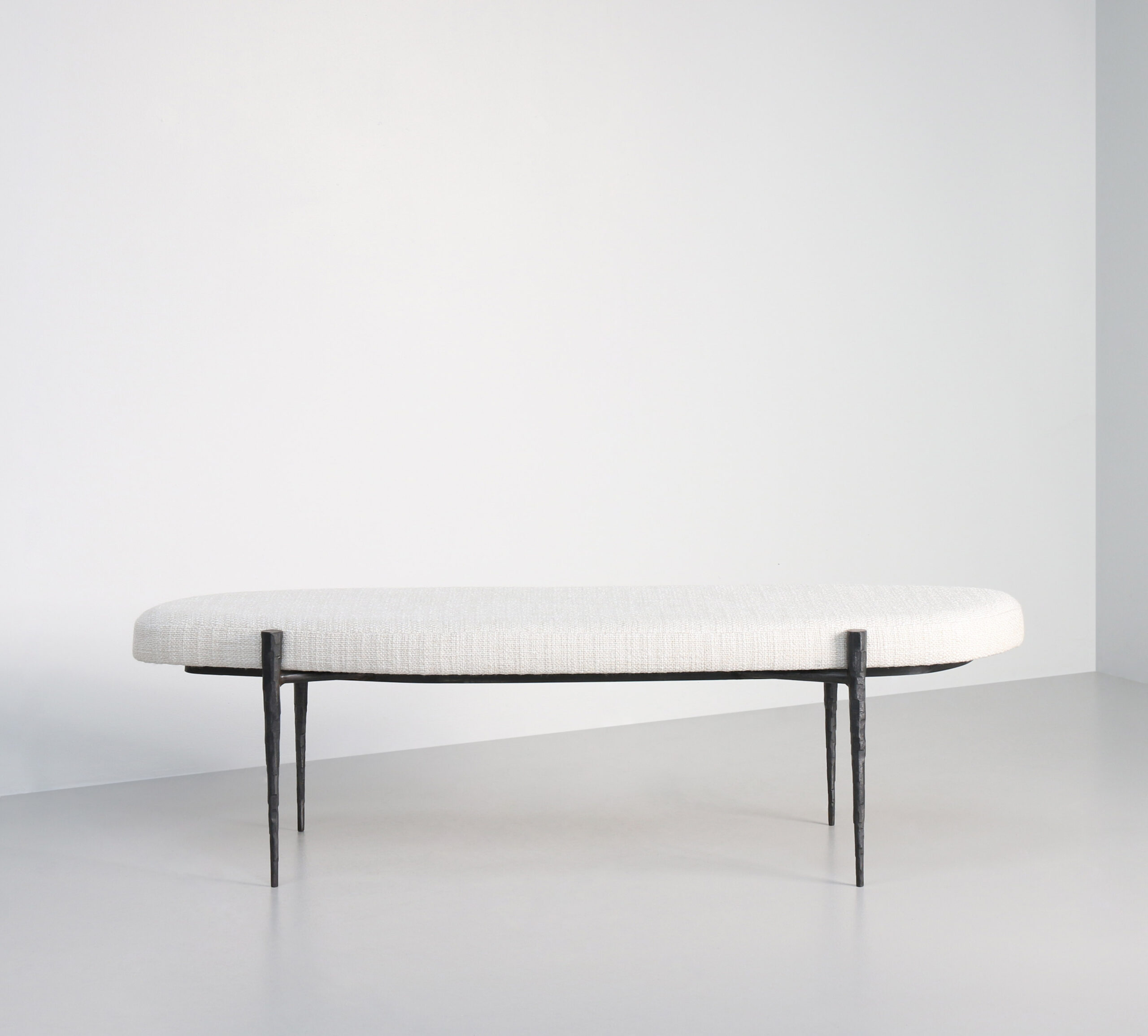 Hammered Steel legs upholstered in a cream boucle