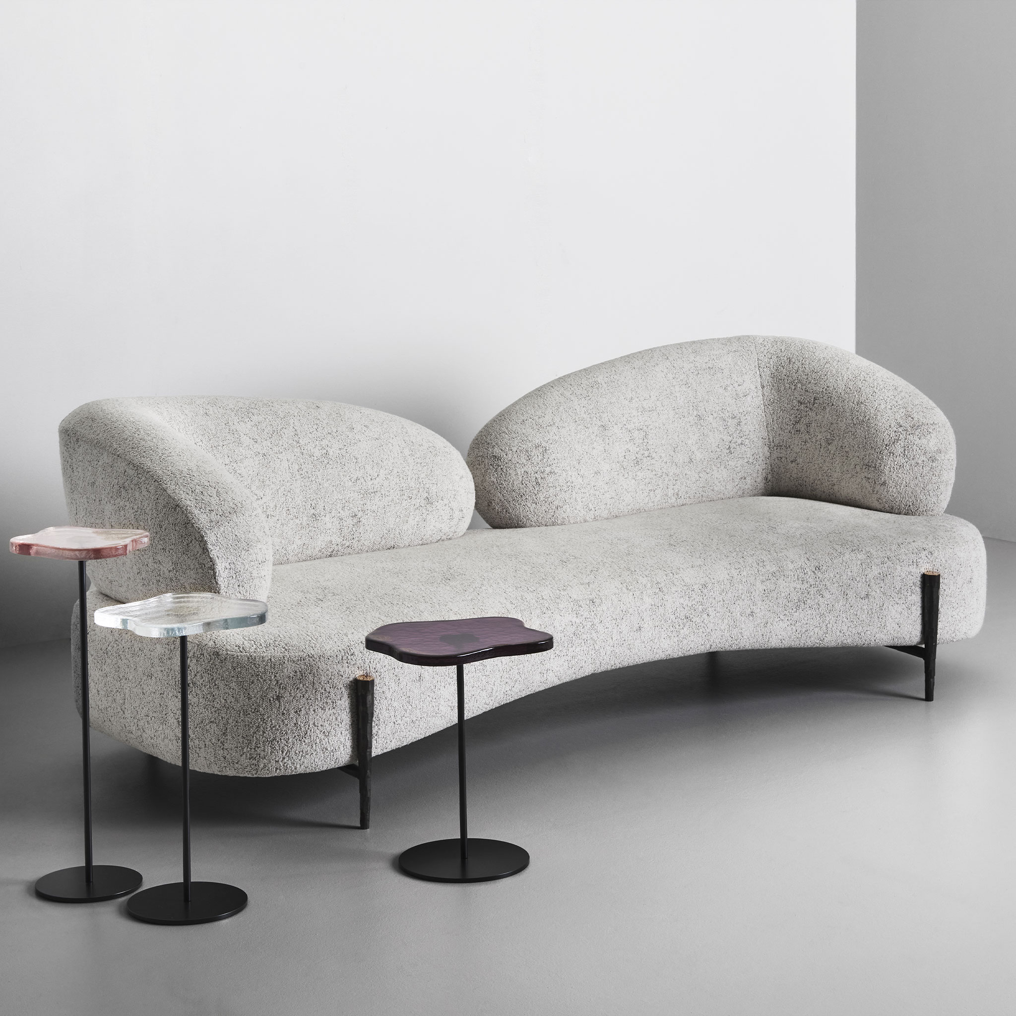 Cloud sofa with hammered bronze legs and three Lily cocktail tables