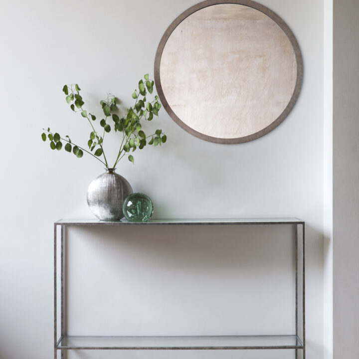 Madison round mirror finished in ‘Burmese Red’ + Lexington console finished in ‘Antique Silver’ with a Silver Leaf verre eglomise top