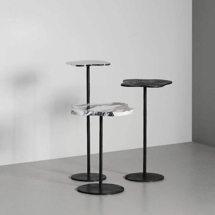Lily cocktail tables with tops of Moon, Breccia marble, and polished stainless steel + Moon stems and bases
