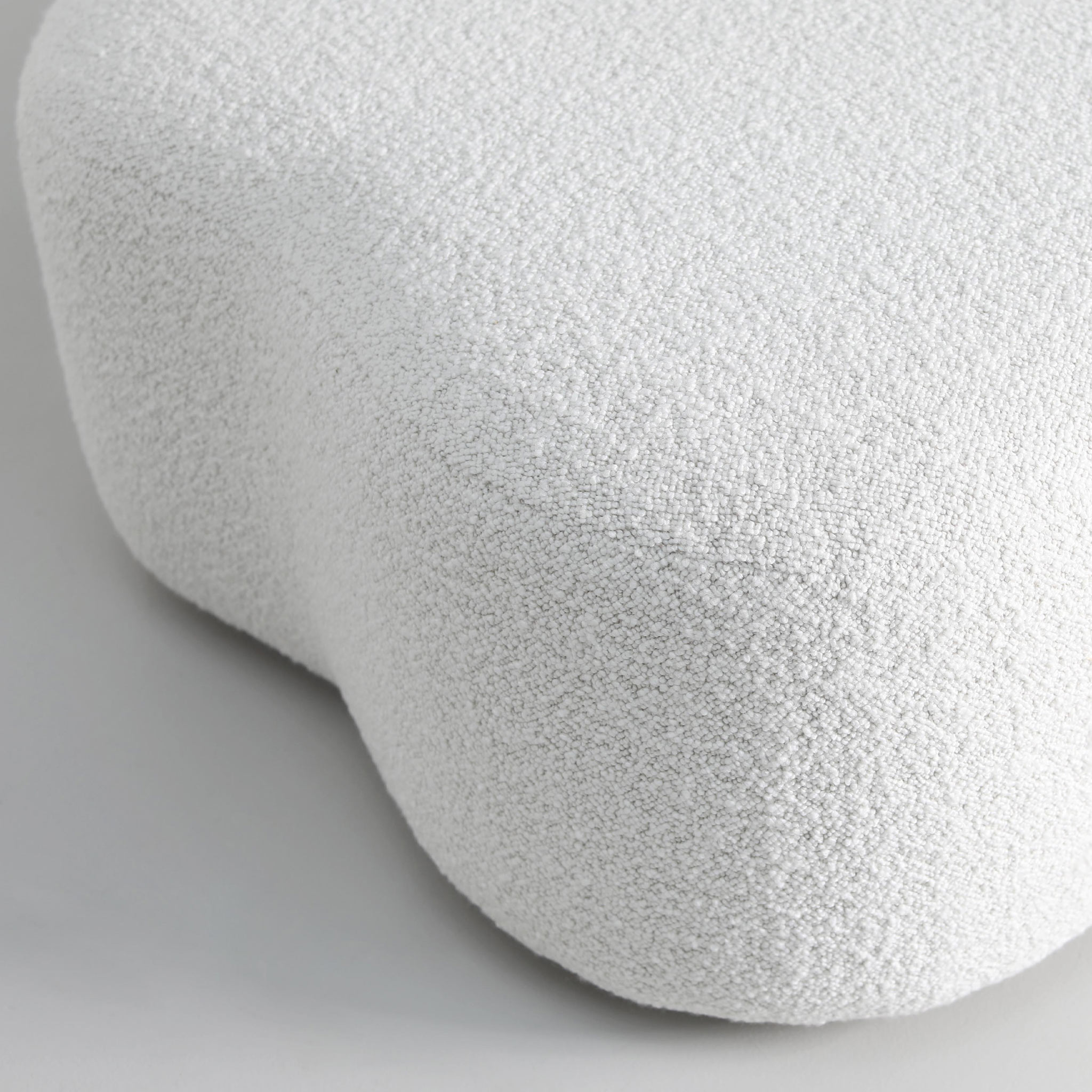 Upholstered in a white Bouclé fabric
