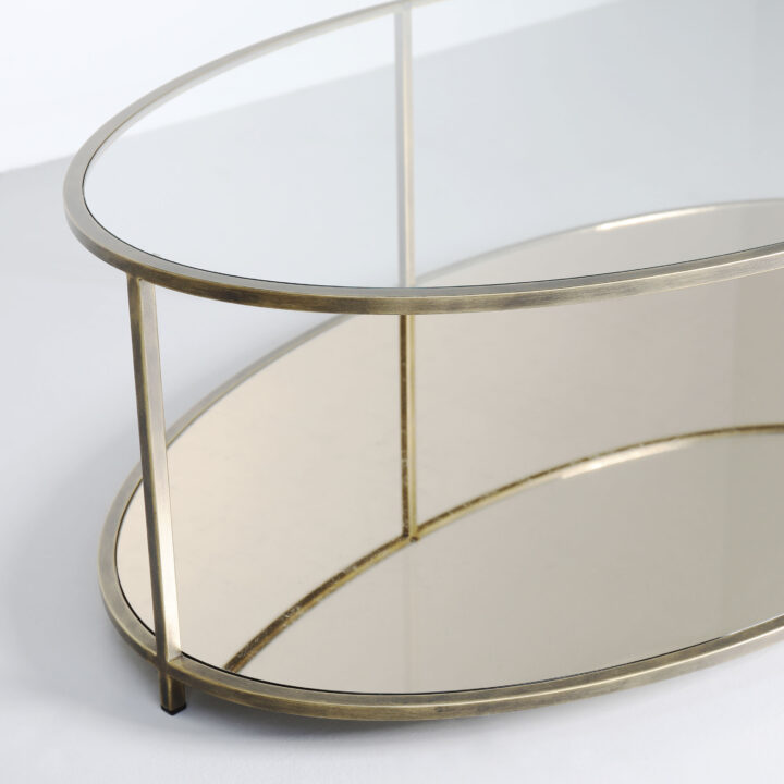Finished in "Florentine Gold" with a "Champagne Verre Eglomise" glass shelf