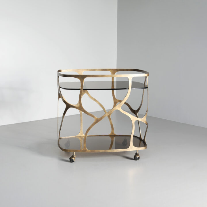 Finished in Florentine Gold with a smoked glass top and shelf