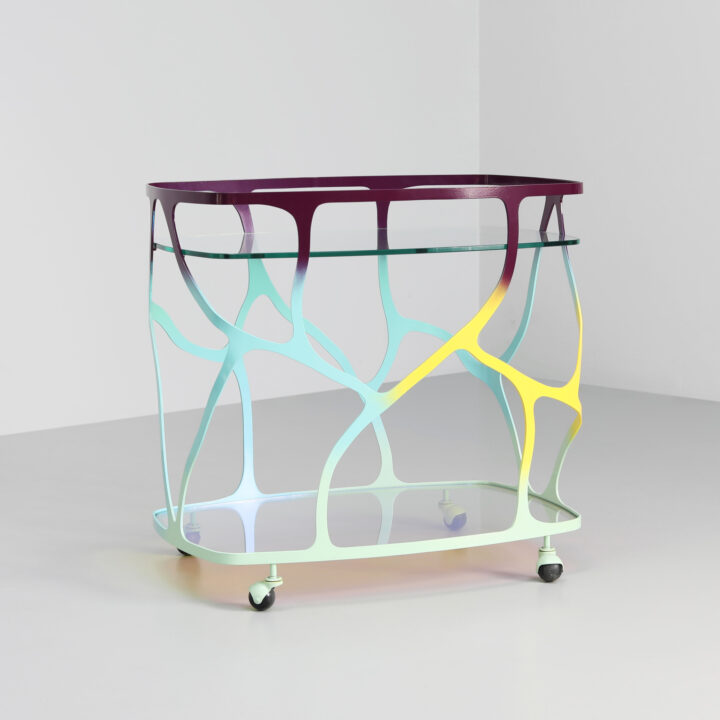 Finished in "Macheon" with a dichroic glass top and shelf