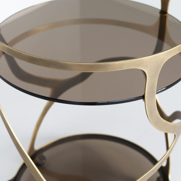 Finished in Florentine Gold with a smoked glass top and shelf