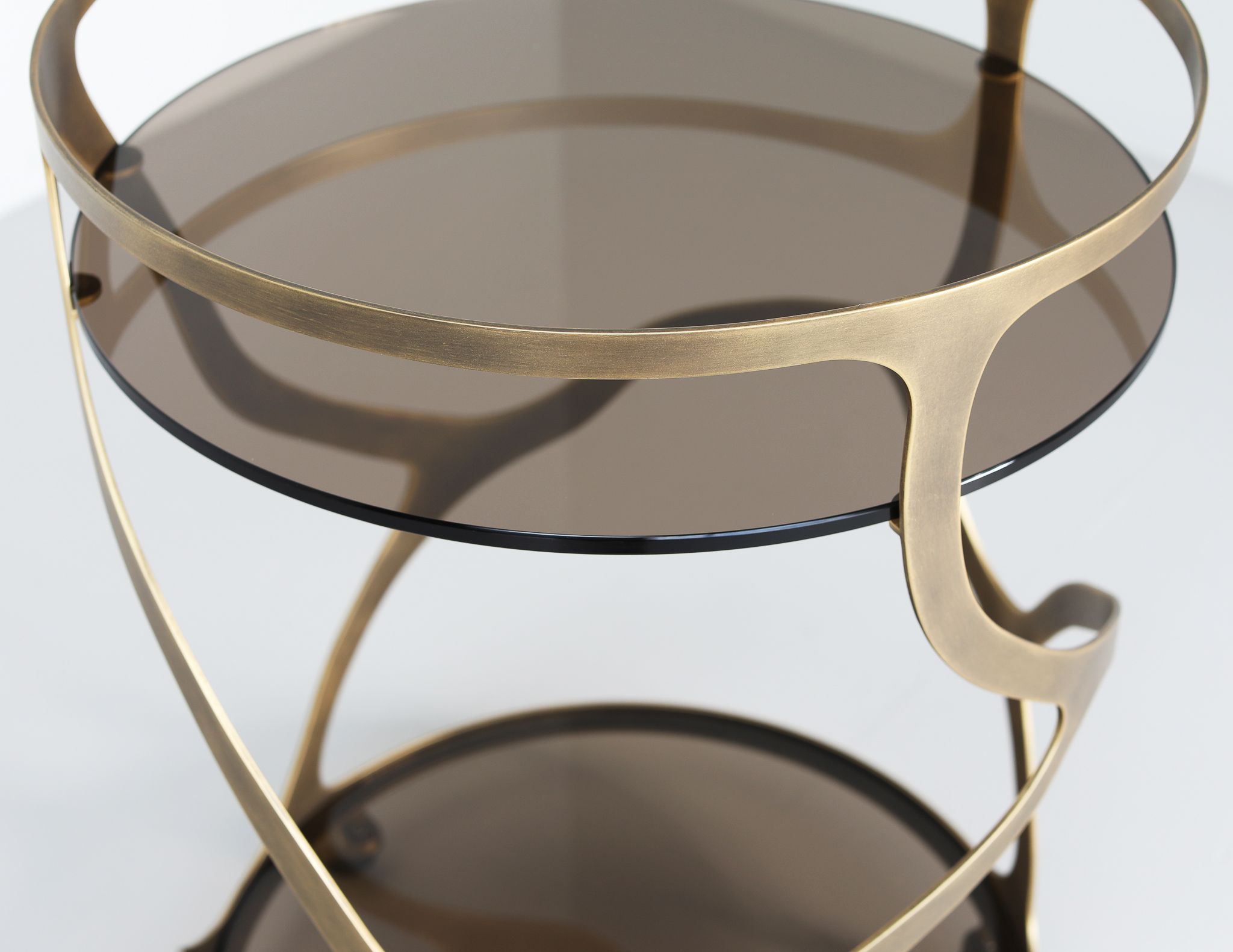 Finished in Florentine Gold with a smoked glass top and shelf