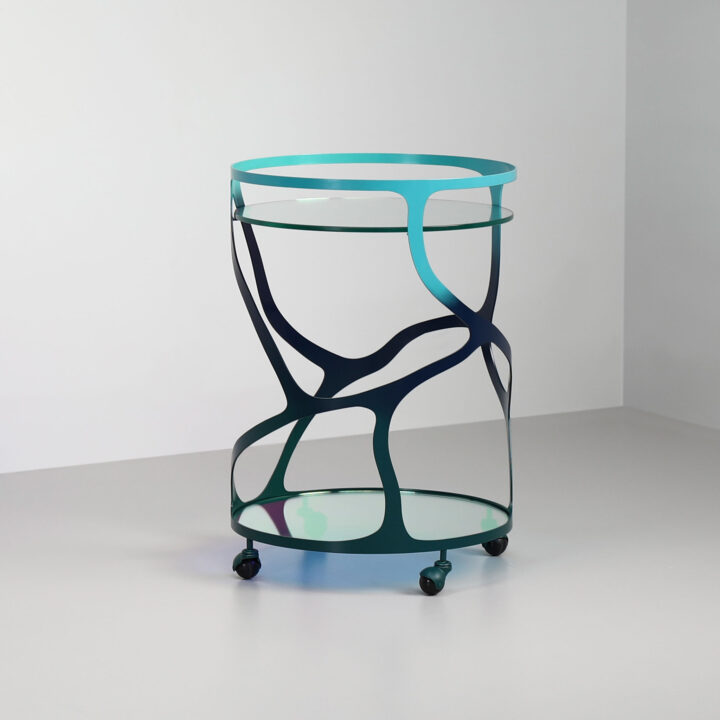 Finished in "Ulysses Blue" with a dichroic glass top and shelf