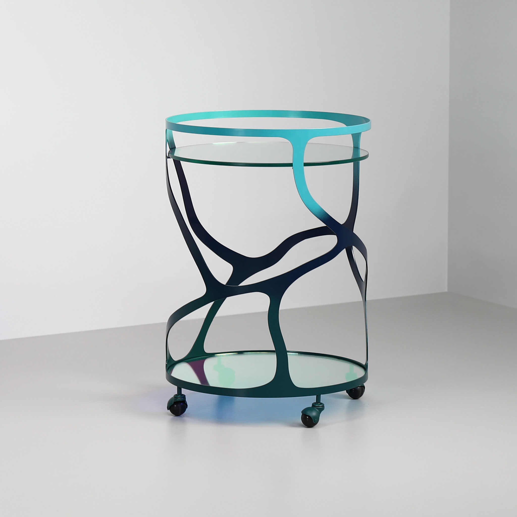 Finished in "Ulysses Blue" with a dichroic glass top and shelf
