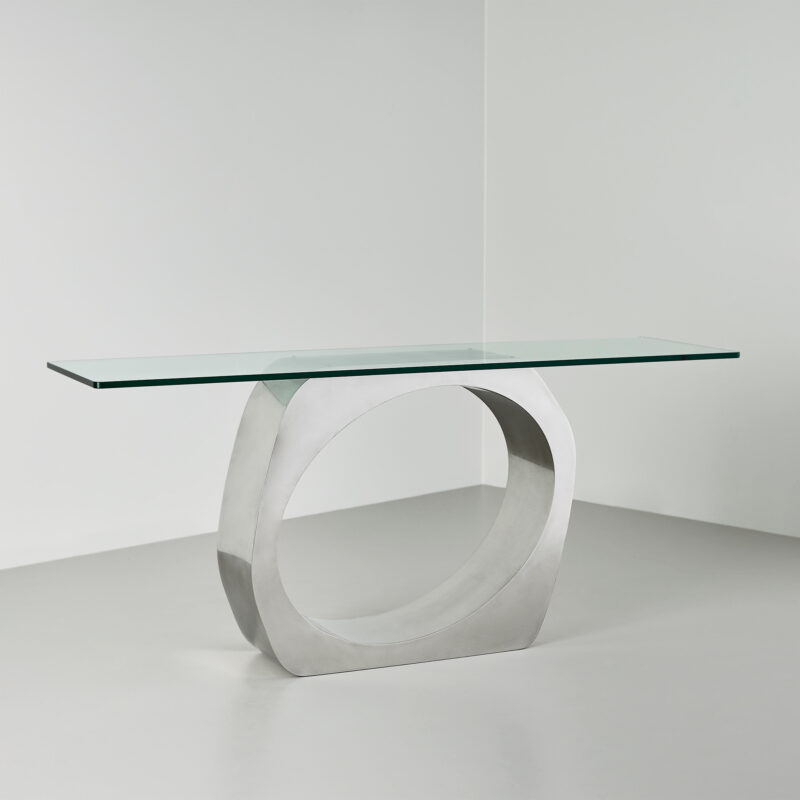 sculptural metal console table with glass top