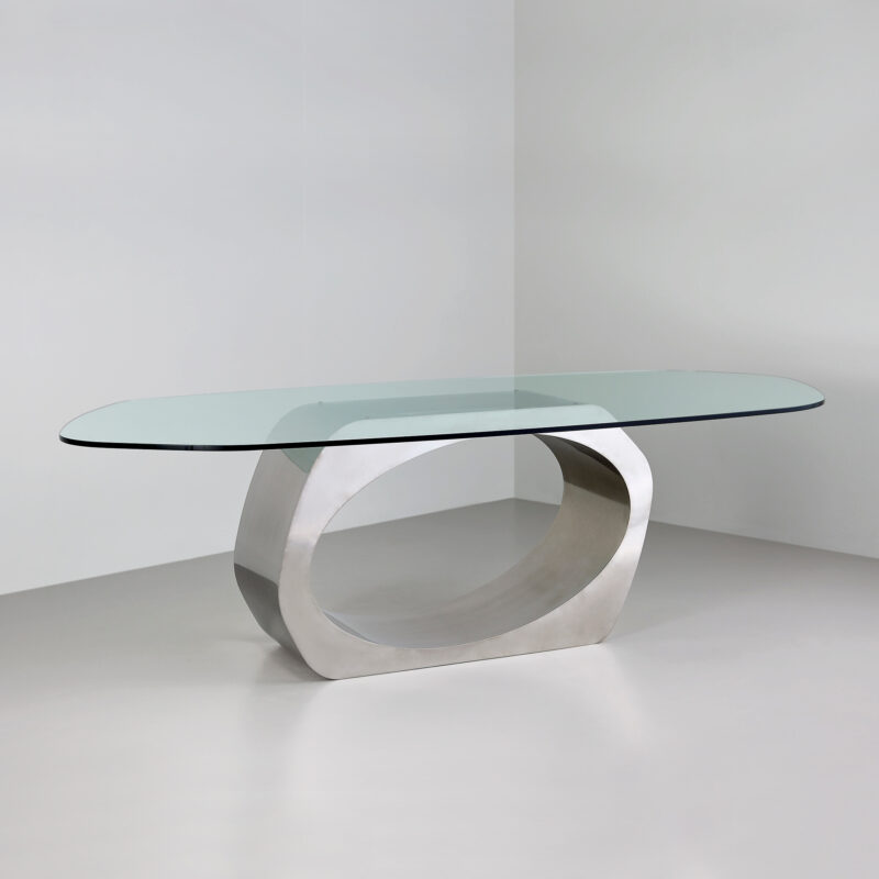 sculptural metal dining table with glass top