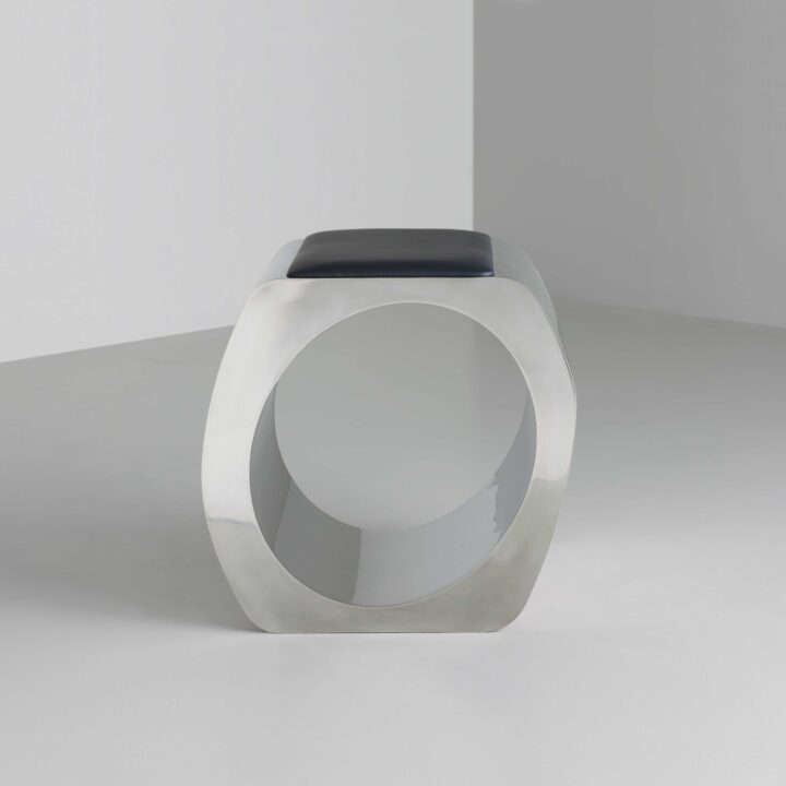 Made in stainless steel with a satin polish and upholstered in black leather