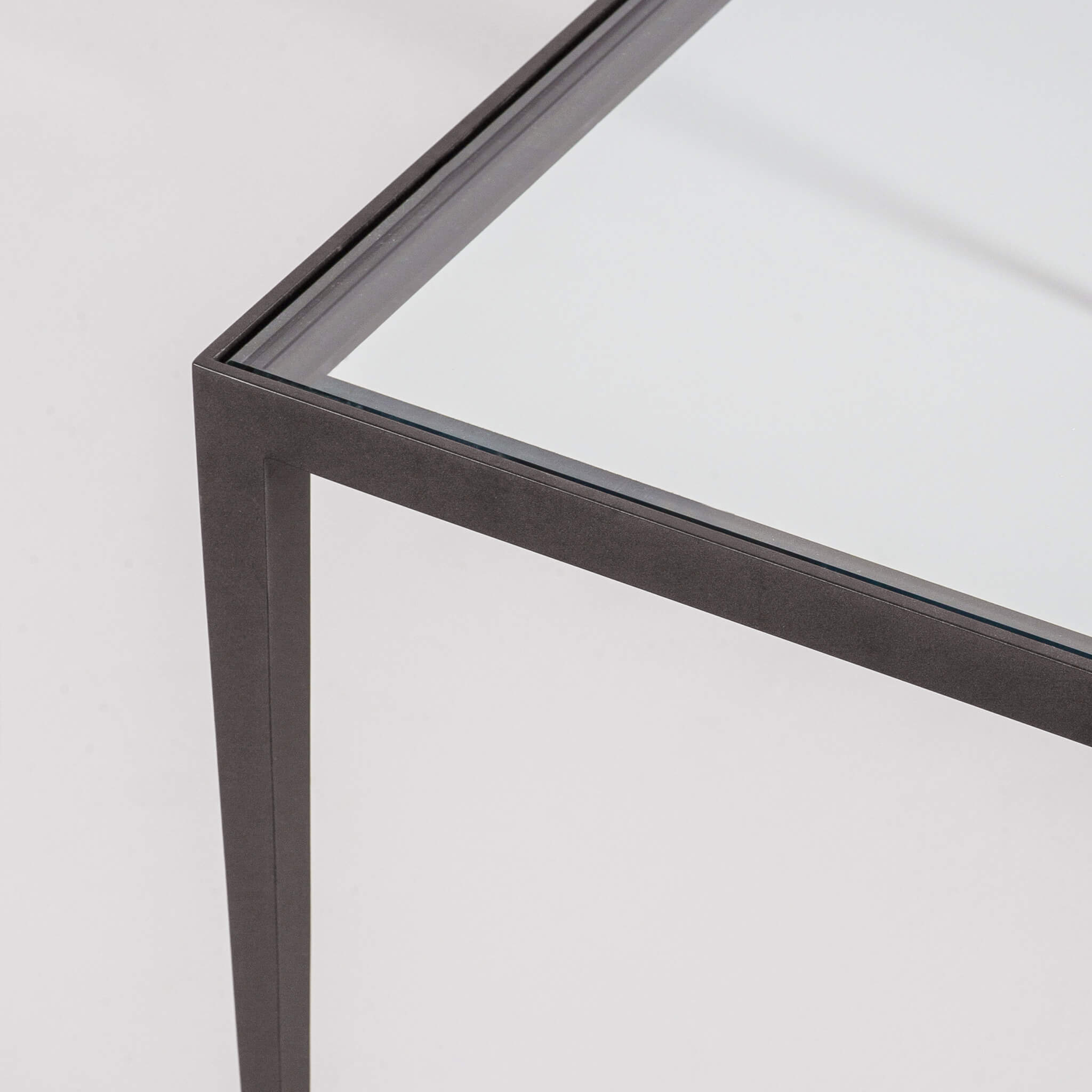 Finished in "Bronze" with a clear glass top